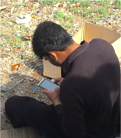 A man in Pakistan uses a smartphone