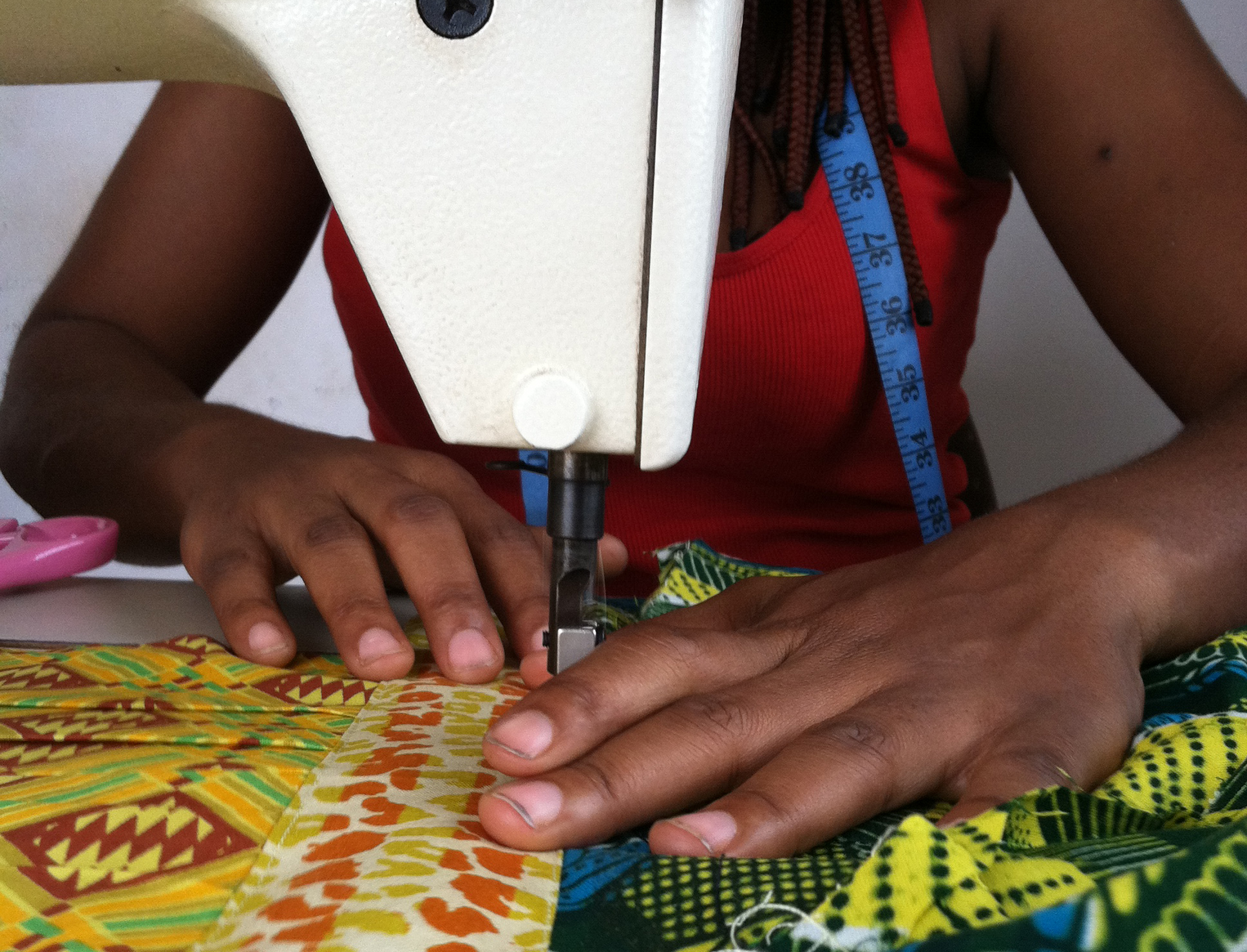 A tailoring apprentice in Ghana using an overlocking sewing machine. © 2014 Morgan Hardy