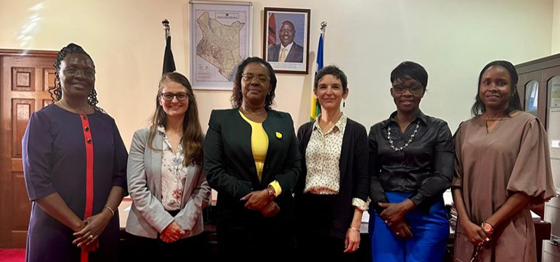 Annie standing with a group of people including IPA Kenya staff