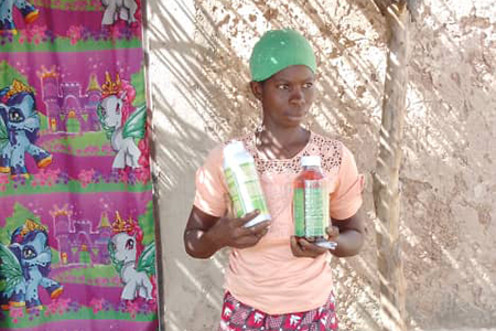 Photo of farmer showing the village inputs she received