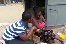 A microentrepreneur in Ghana interviews with an IPA surveyor