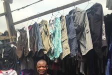 A used clothing trader and his stock in Lagos, Nigeria A used clothing trader and his stock in Lagos, Nigeria