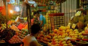 A Filipino micro entrepreneur works at his fruit stand