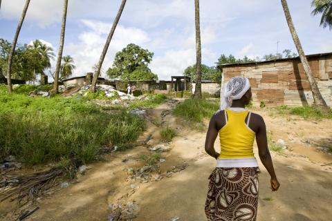 A photo of a young woman walking in Liberia with her back turned to the camera. © 2010 Glenna Gordon