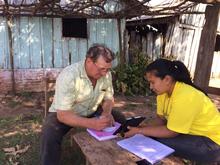 A surveyor working with a study participant. A surveyor working with a study participant.